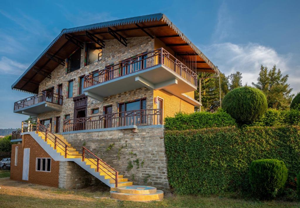 a house with a staircase in front of it at BluSalzz Homes - The Himalayan Bungalow, Almora - Uttarakhand in Almora