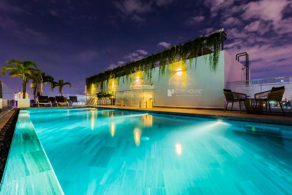 a swimming pool at night with a building at CityHouse - Kim Nguyên in Ho Chi Minh City