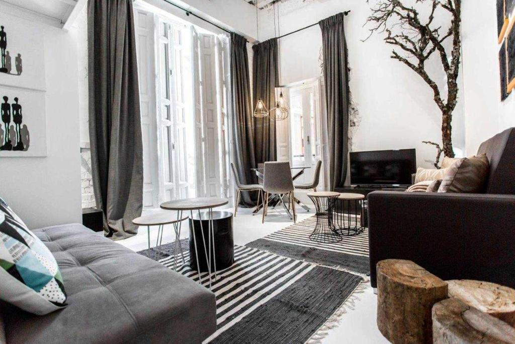 a living room with a couch and a table at Almudena Modern y luxury space near Plaza Mayor in Madrid