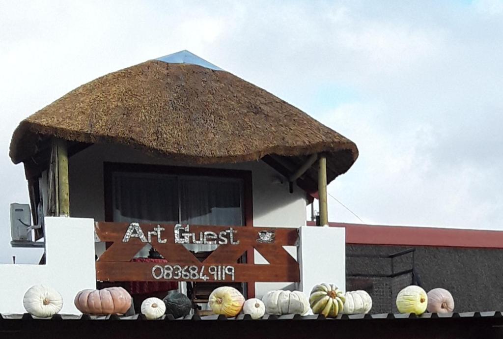 an exhibit of different types of pumpkins in front of a building at Art Guest House in Lutzville