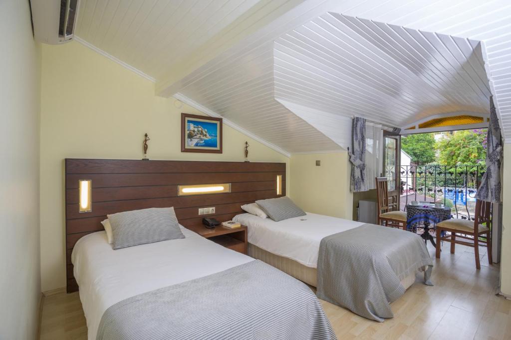 Postel nebo postele na pokoji v ubytování Hotel Villa Daffodil