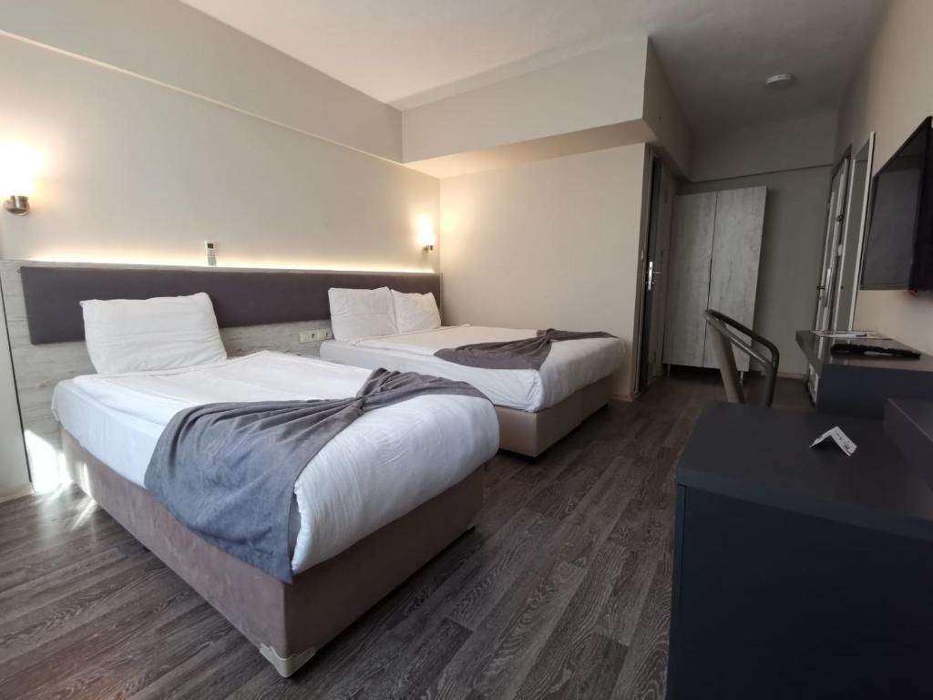 Postel nebo postele na pokoji v ubytování Temizay Hotel