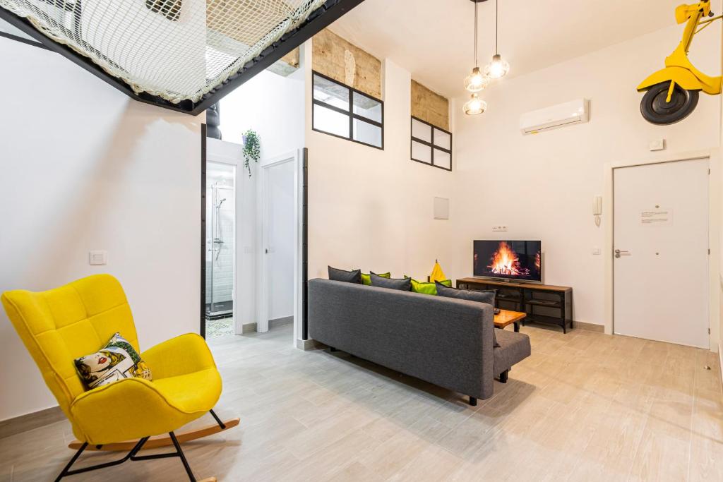 a living room with a couch and yellow chairs at Ever House - ALCALA LOFT in Madrid
