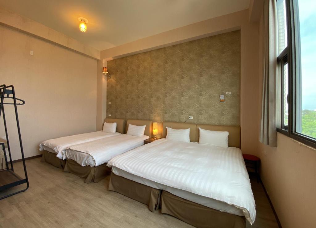 Postel nebo postele na pokoji v ubytování IN99 Hotel