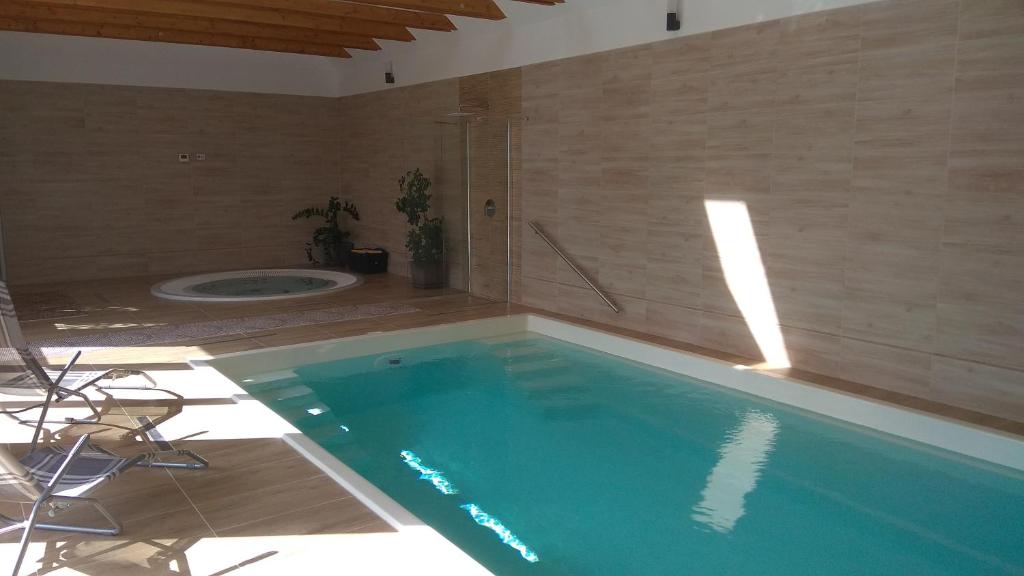 a swimming pool with a tub in a bathroom at Nádas Panzió in Tiszafüred