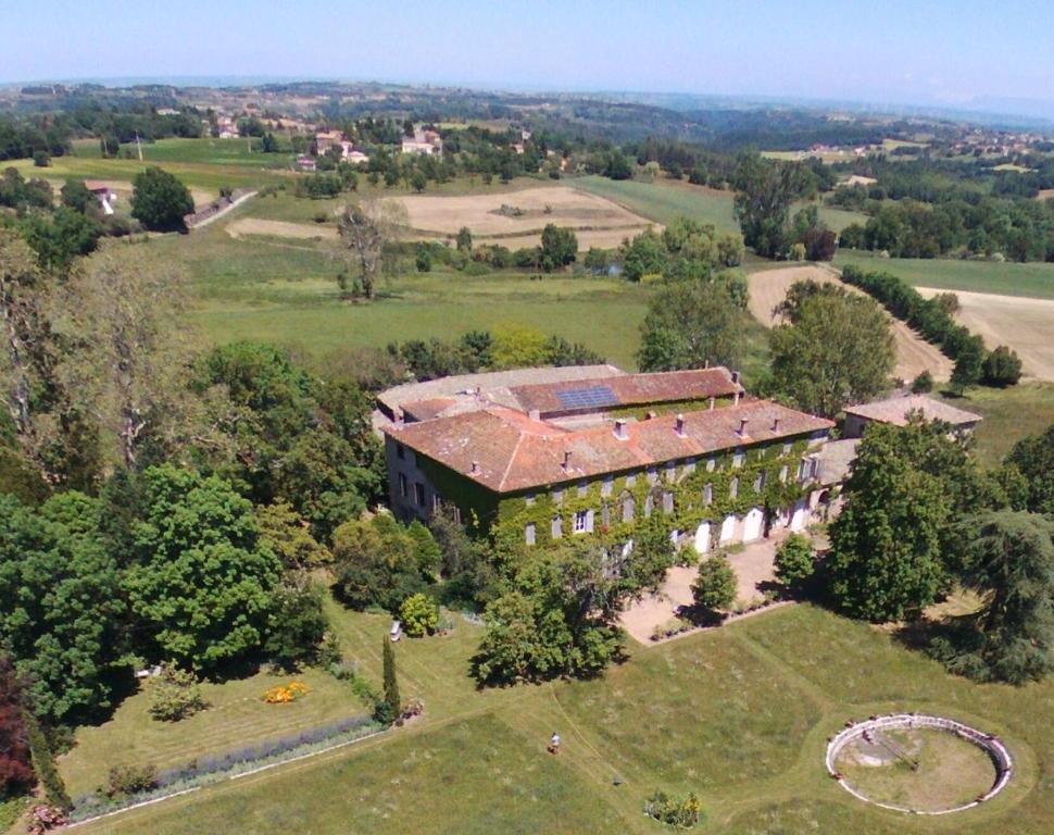 an aerial view of an old house in a field at Domaine du Peyron in Quintenas