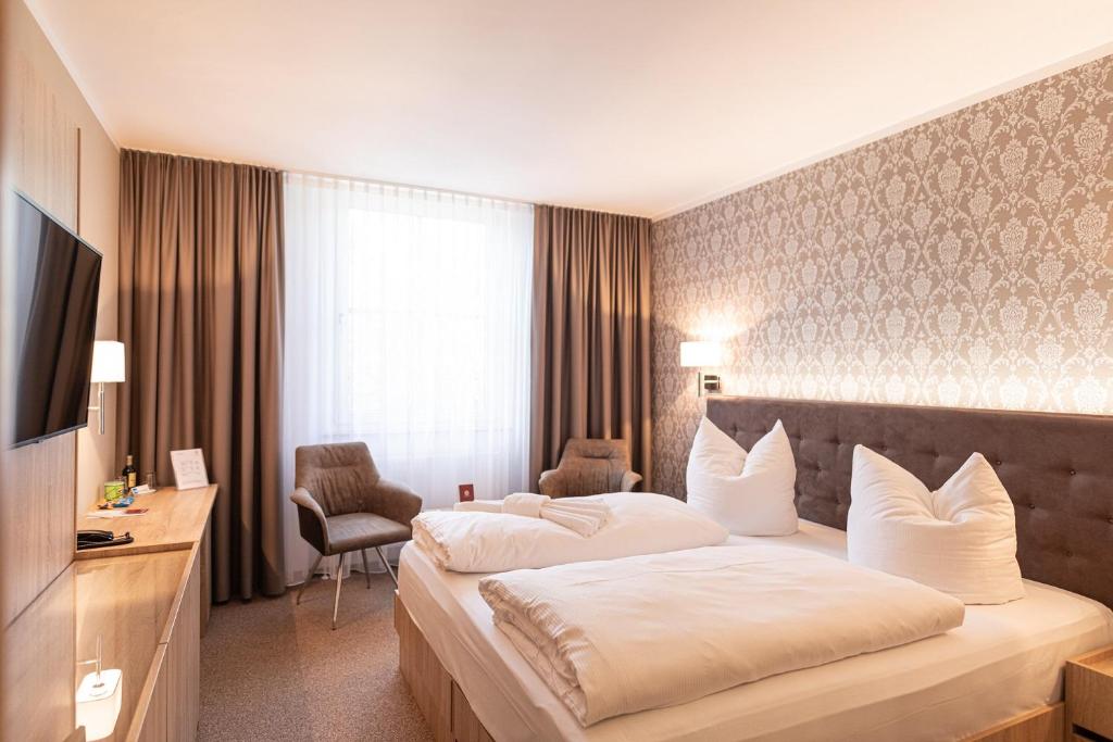 Postel nebo postele na pokoji v ubytování Schloss Breitenfeld Hotel & Tagung