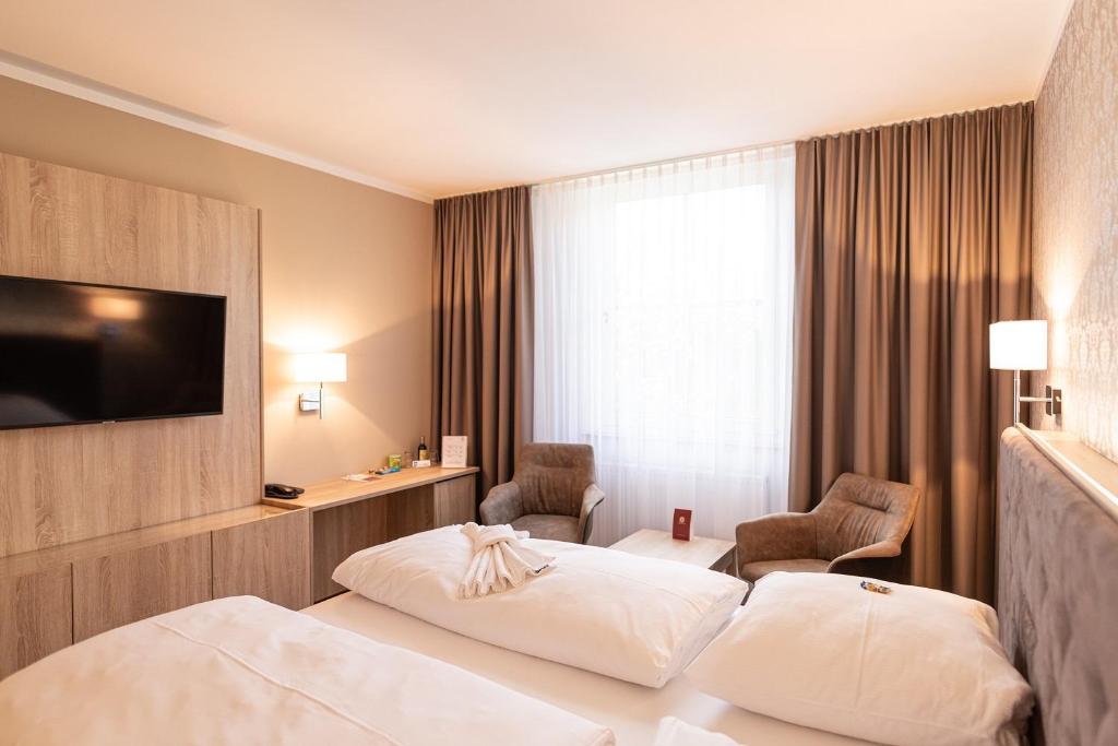 Postel nebo postele na pokoji v ubytování Schloss Breitenfeld Hotel & Tagung