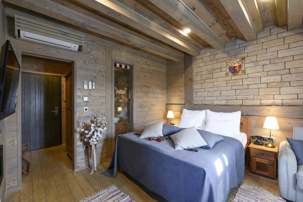 A bed or beds in a room at Ethno Houses Plitvice Lakes Hotel