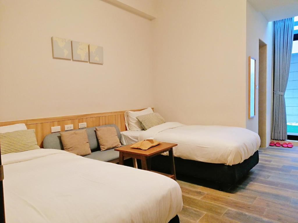 Postel nebo postele na pokoji v ubytování See U Tainan Apartment