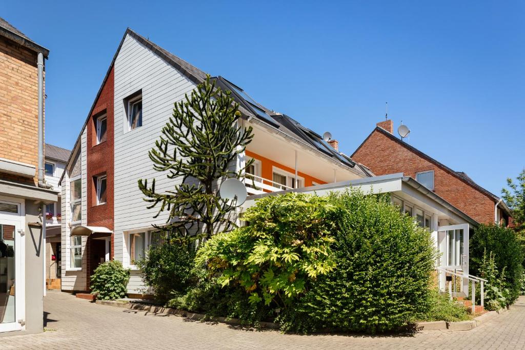 a street in a town with houses and a tree at Helgolandia Apartments in Helgoland