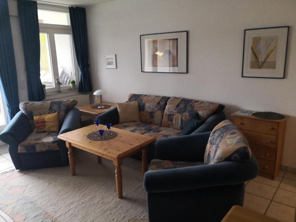 a living room with two couches and a coffee table at Das Landhaus am Haff LHH A04 in Stolpe
