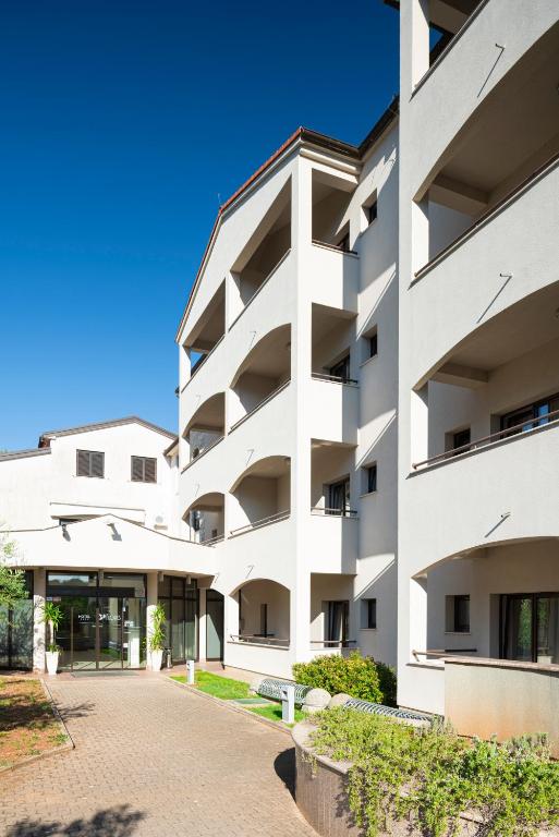 an exterior view of a white building at Hotel Flores in Poreč