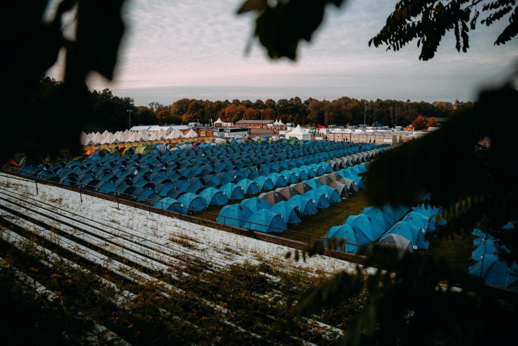 a row of blue chairs in a field at ESN Oktoberfest Campsite in Munich
