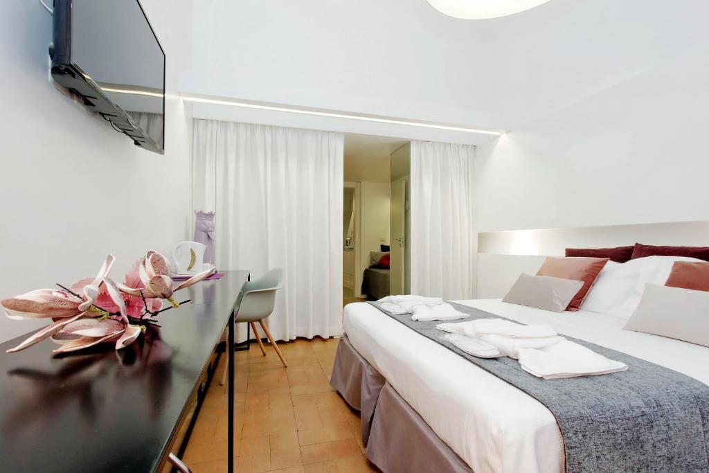 a hotel room with a large bed and a television at B&G Navona Apartment in Rome