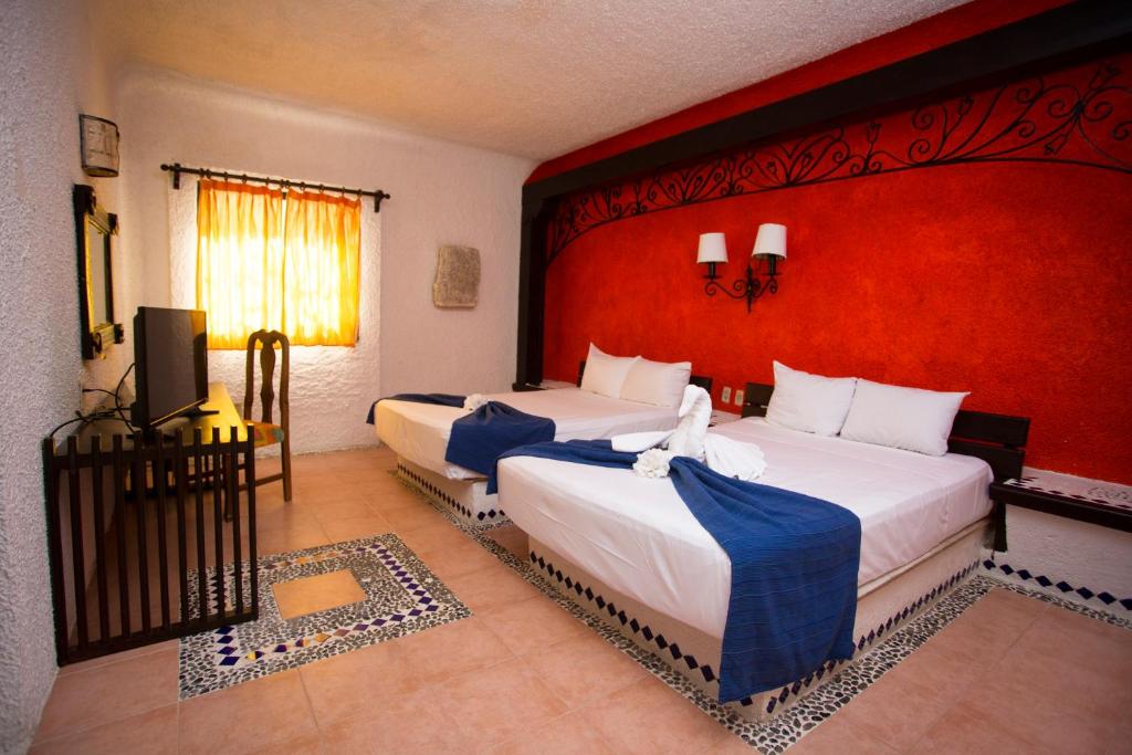 Postel nebo postele na pokoji v ubytování Hotel Xbalamqué & Spa Cancún Centro