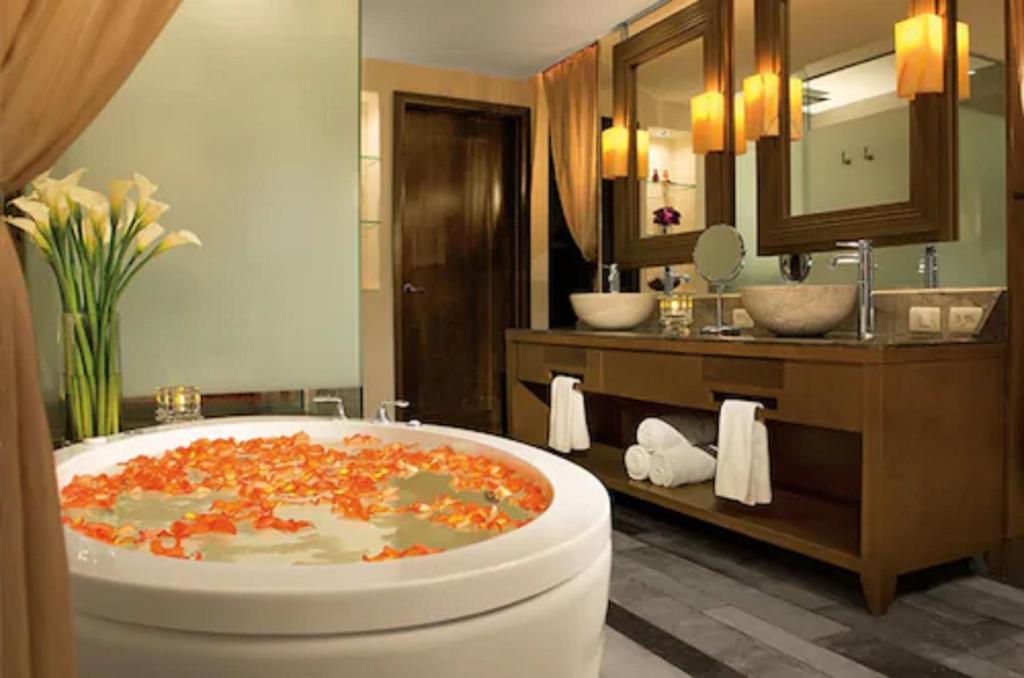 a bathroom with a large bath tub in a room at Secrets Vallarta Bay Resort & SPA - Adults Only in Puerto Vallarta