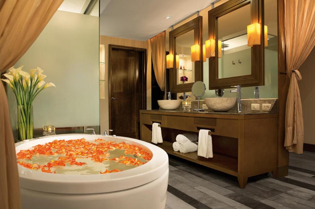 a bathroom with a large bath tub and a sink at Secrets Vallarta Bay Resort & SPA - Adults Only in Puerto Vallarta