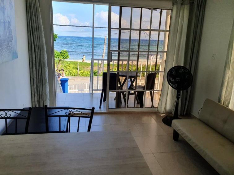 a living room with a view of the ocean at Apartamentos Sound Bay Beach in San Andrés