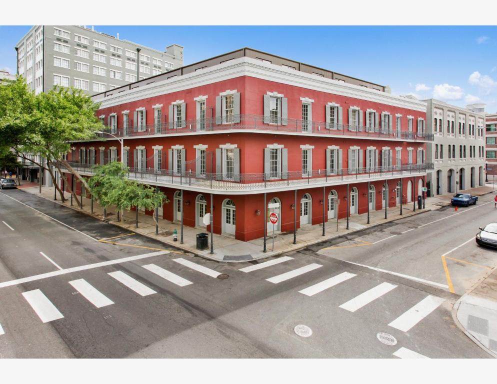 a red building on the corner of a street at The Bordeaux in New Orleans