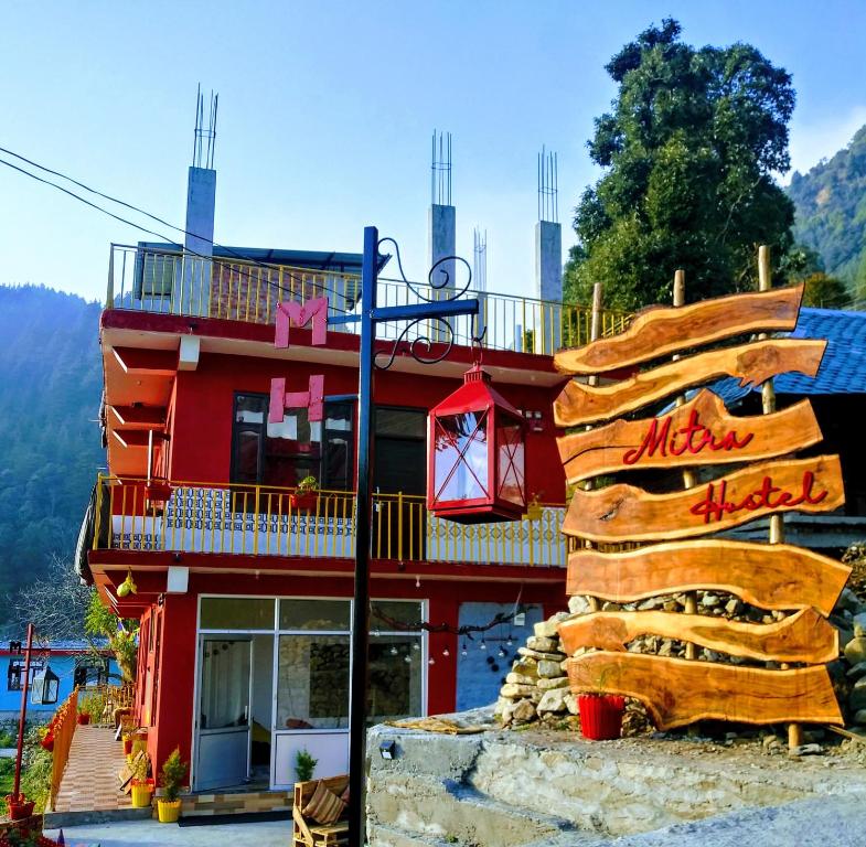 a red building with a sign in front of it at Mitra Homes Dharamkot in McLeod Ganj