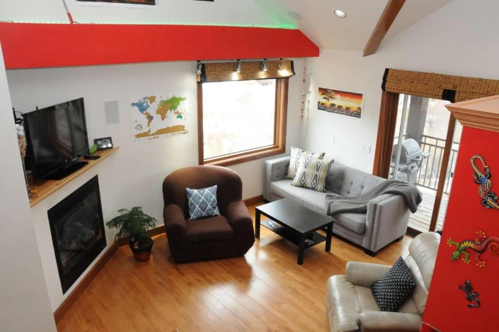 a living room with a couch and chairs and a television at Outlaws Creek in Telluride