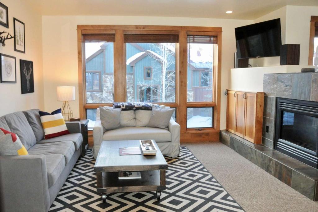 a living room with a couch and a fireplace at Terraces Meadow View in Telluride