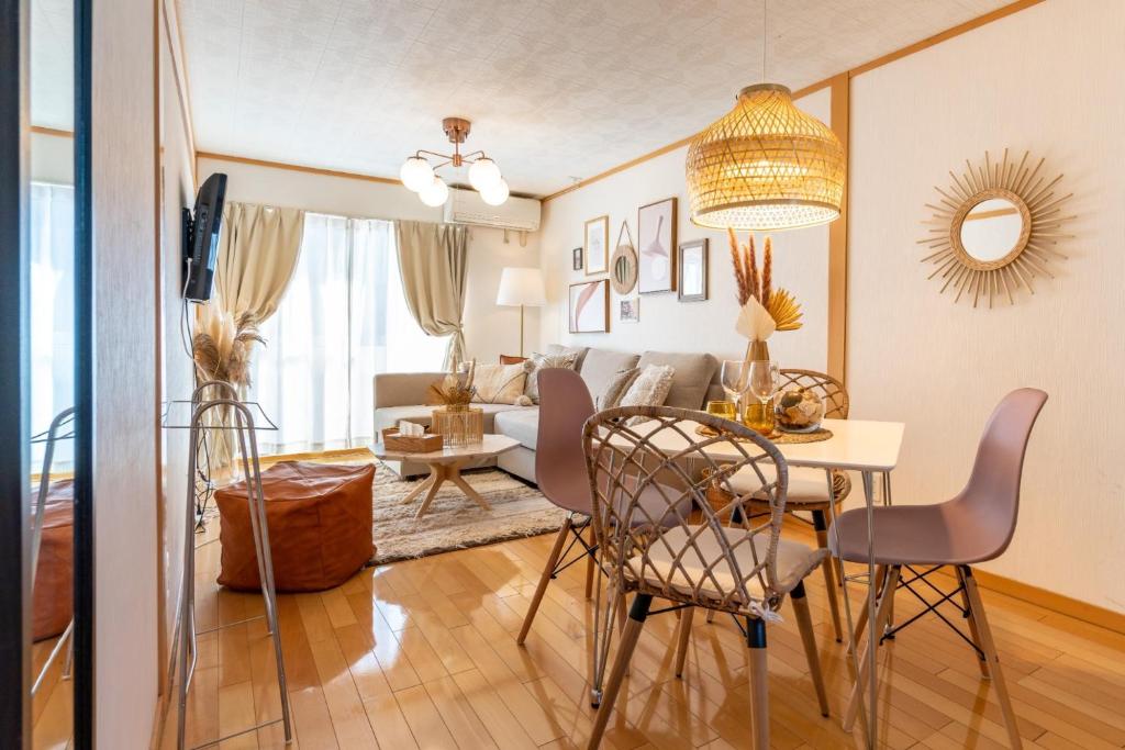 uma sala de estar e de jantar com mesa e cadeiras em ASAHI HOUSE 2nd floor - Vacation STAY 92921 em Naha