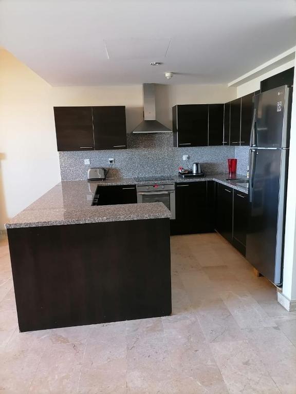 Kuchyň nebo kuchyňský kout v ubytování Le Sifah - Marina View Apartments & Villa
