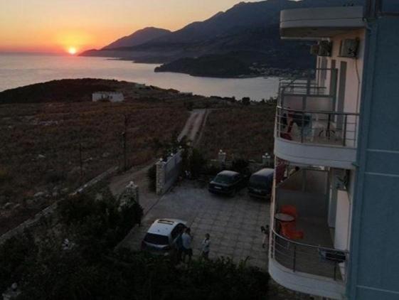 a view of a sunset from a balcony of a building at Vila Llaka in Himare
