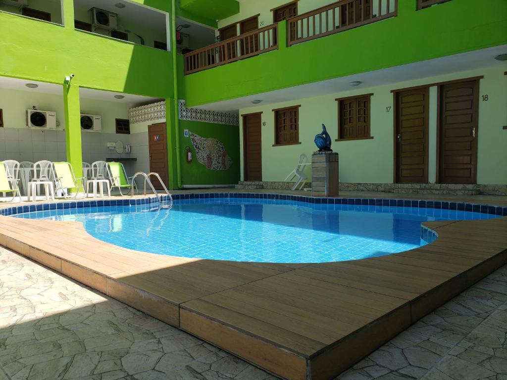 a large swimming pool in a large building with at Pousada Ouriço in Porto De Galinhas