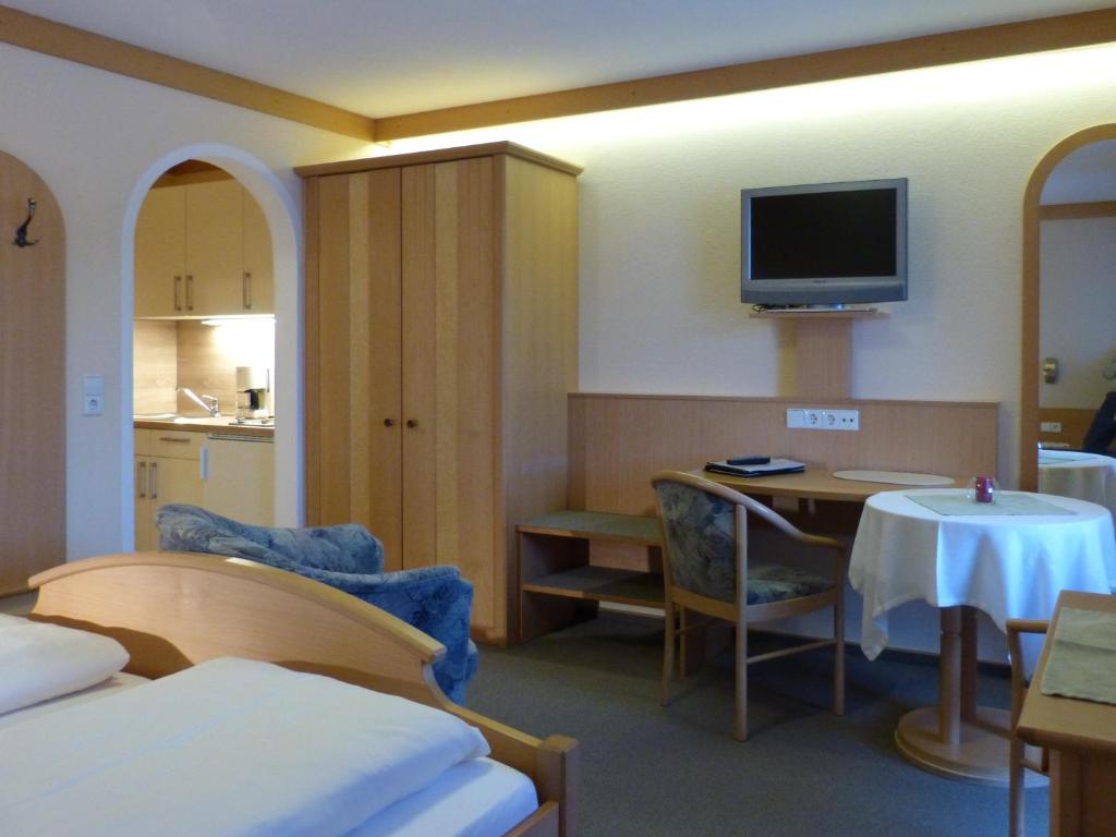a hotel room with a table and a tv on the wall at Giglerhof in Bad Birnbach