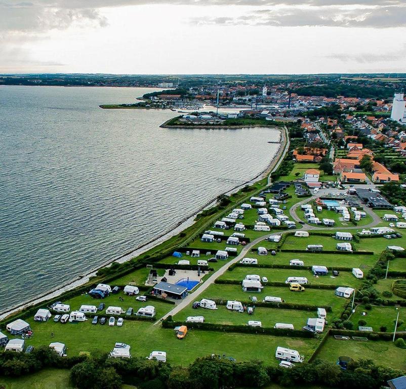 an aerial view of a parking lot next to the water at Thisted Camping & Cottages in Thisted