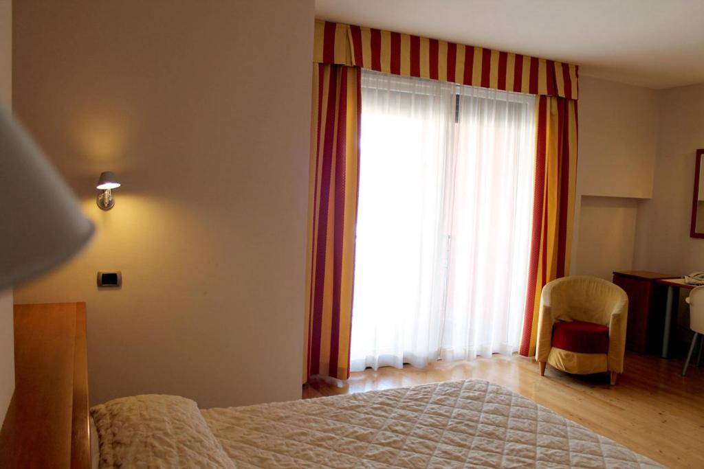 Postel nebo postele na pokoji v ubytování Hotel Rubicone
