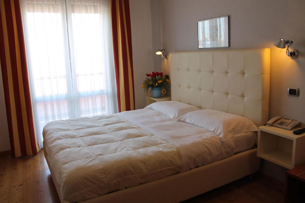 Postel nebo postele na pokoji v ubytování Hotel Rubicone