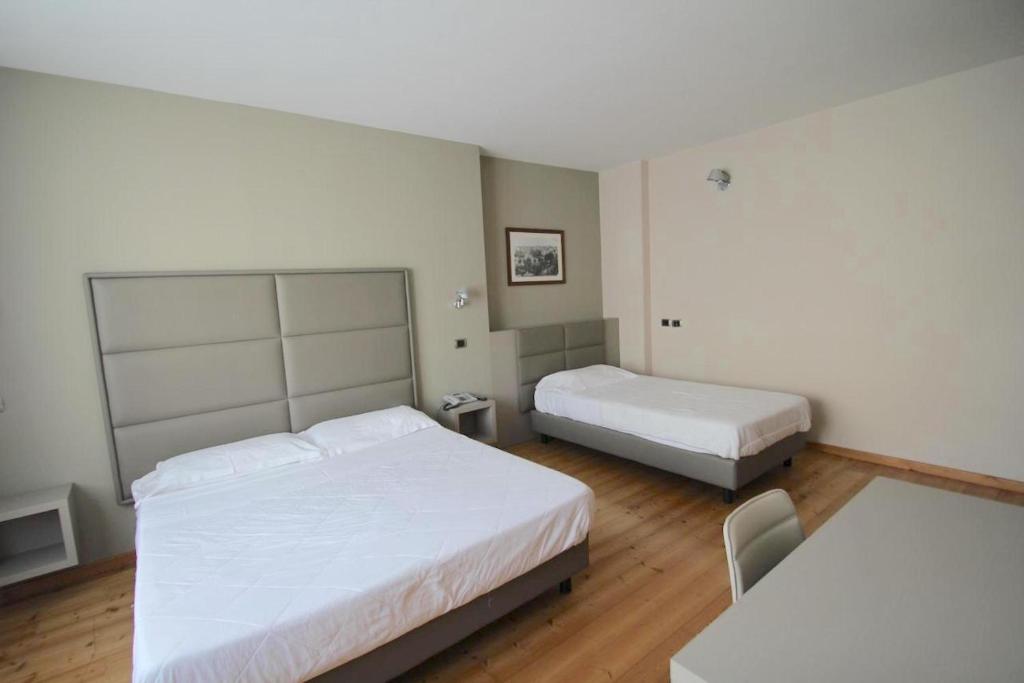 Postel nebo postele na pokoji v ubytování Hotel Rubicone