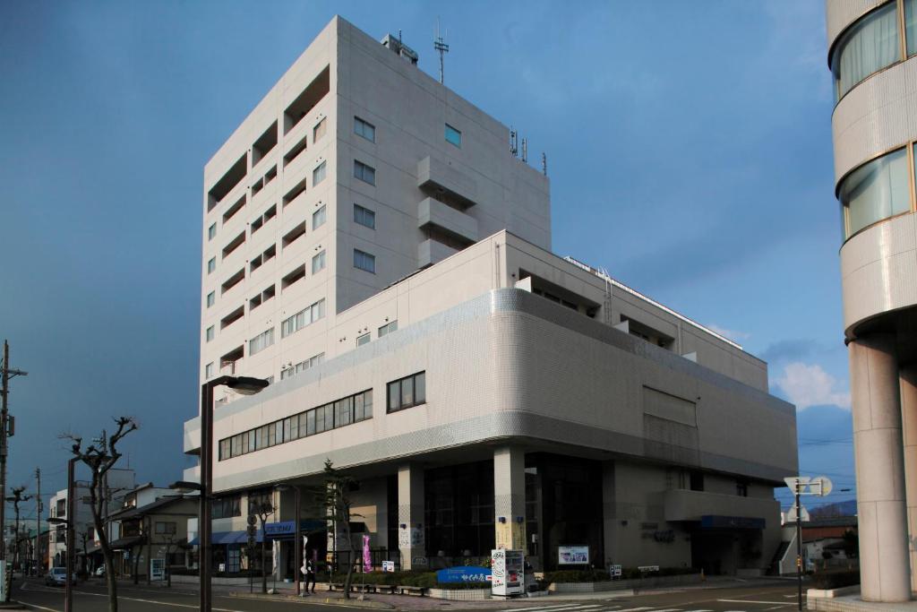 a large white building on a city street at Hotel Sekumiya in Obama