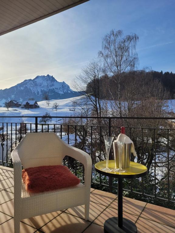 a table and a chair on a balcony with a view at Villa Castagna Guesthouse in Lucerne