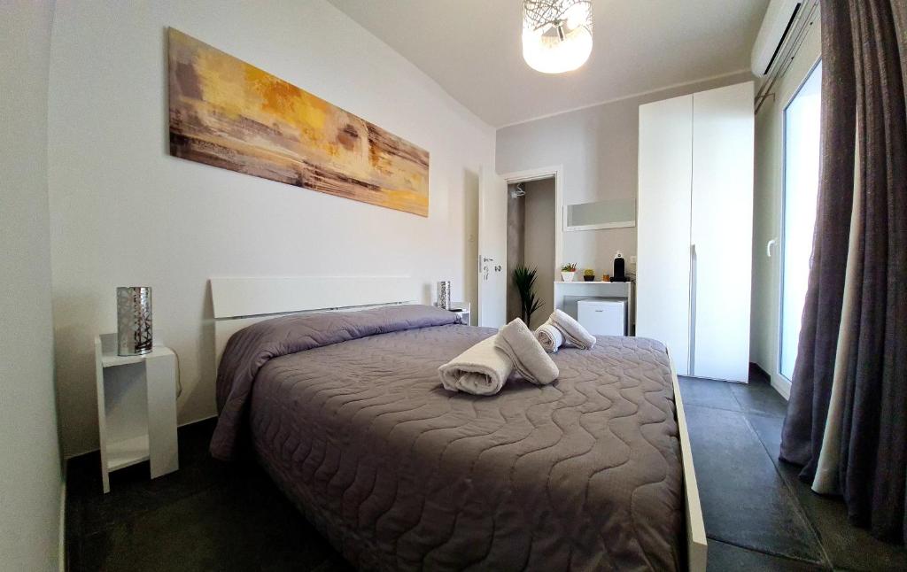 a bedroom with a bed with towels on it at SCRUSCIU HOME in Terrasini