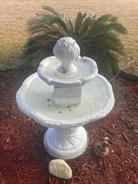 a white fountain with a lion on top of it at Nassau Holiday Motel in Yulee