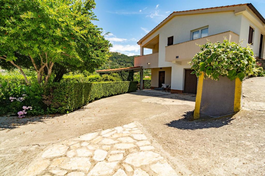a house with a plant in front of it at Apartment Dumičić 1 in Rab