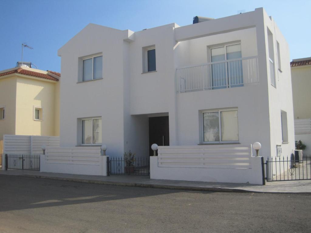 a white house with white fences in front of it at Polyxenia Isaak Villa Dafni in Protaras
