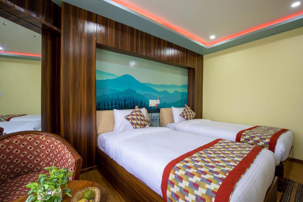 En eller flere senge i et værelse på Siddhartha Hotel Grand City