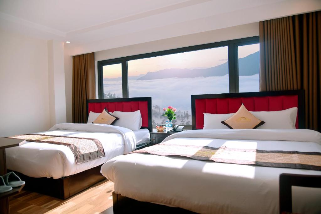 Postel nebo postele na pokoji v ubytování SAPA KING HOTEL HUNG VUONG HOTEl
