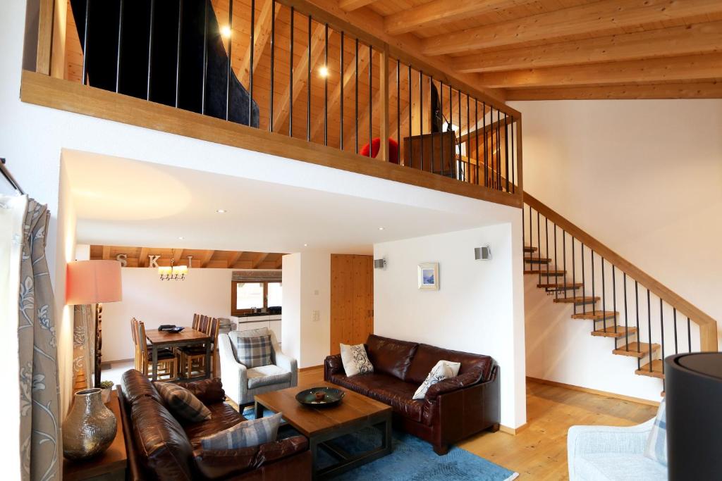 a living room with a couch and a staircase at Pyrit in Saas-Fee