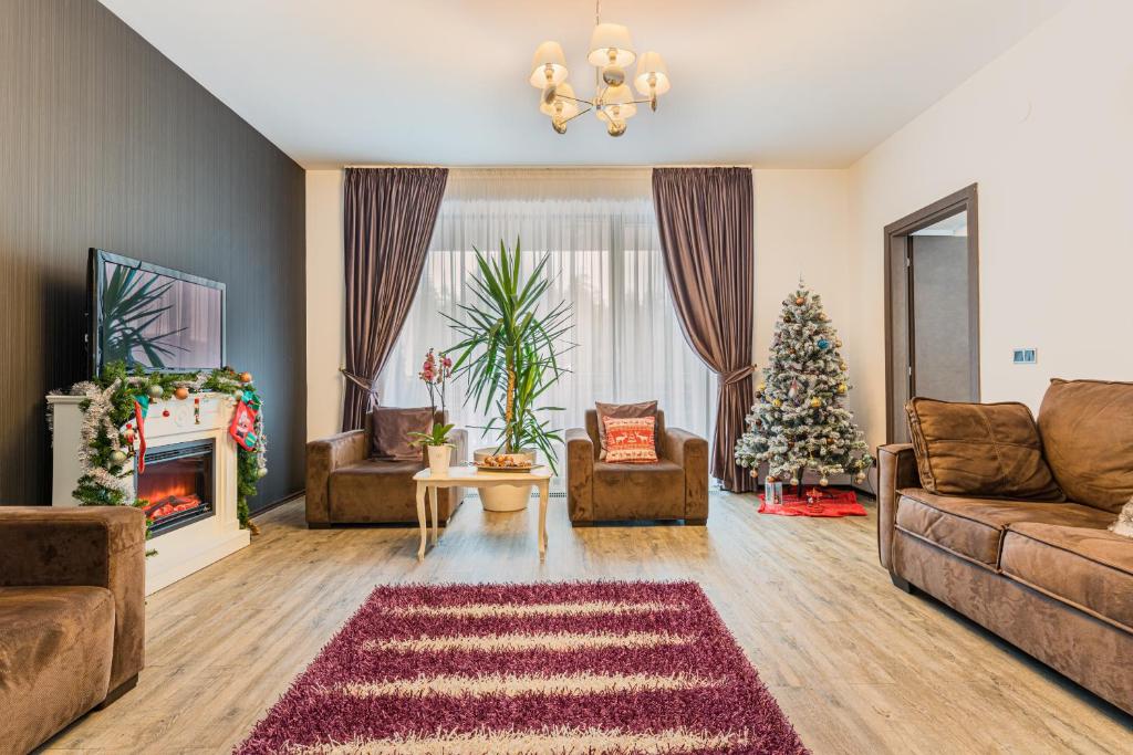 a living room with a christmas tree and a couch at Ambient apartment in Silver Montain - Poiana Brasov in Poiana Brasov
