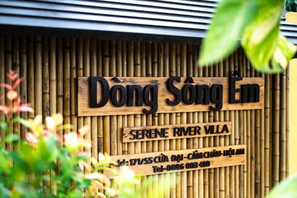 a sign for a doing song hi on a bamboo wall at Serene River Hoian in Hoi An