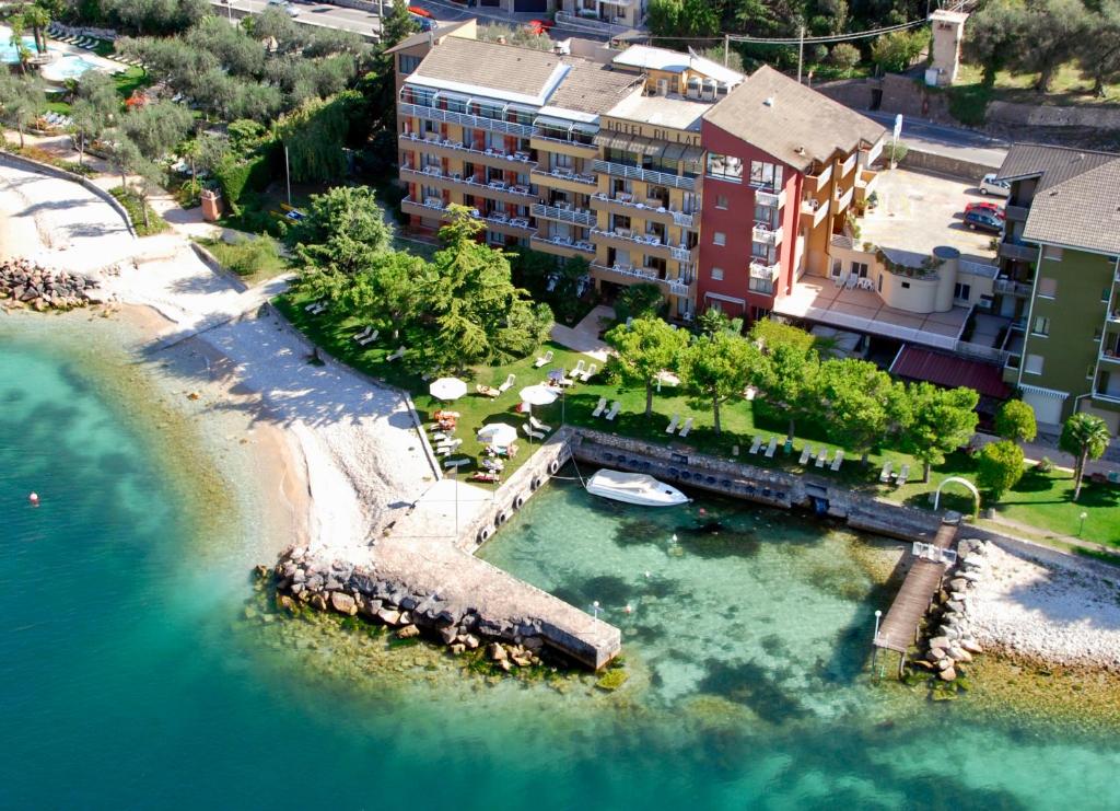 una vista aérea de un cuerpo de agua con un complejo en Hotel Du Lac - Relax Attitude Hotel, en Brenzone sul Garda