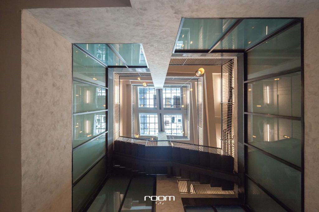 a hallway in a building with a window at Luk Hostel in Bangkok
