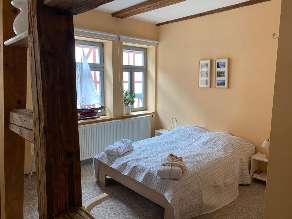 a bedroom with a bed with towels on it at Gaststätte Brandenburg in Nordhausen